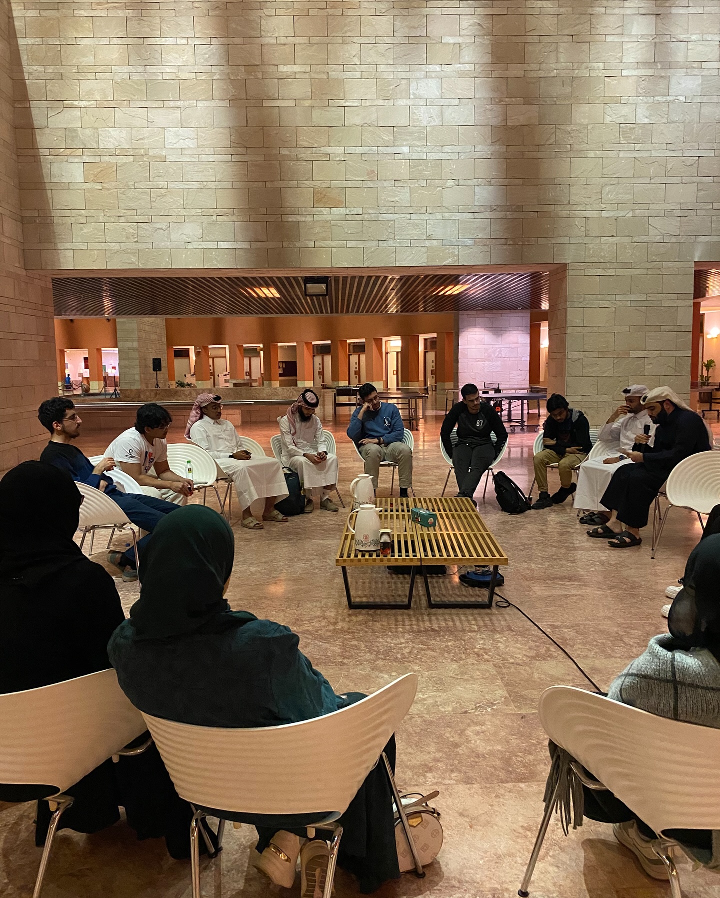 Students seated in a circle during a Karak and Kookies discussion