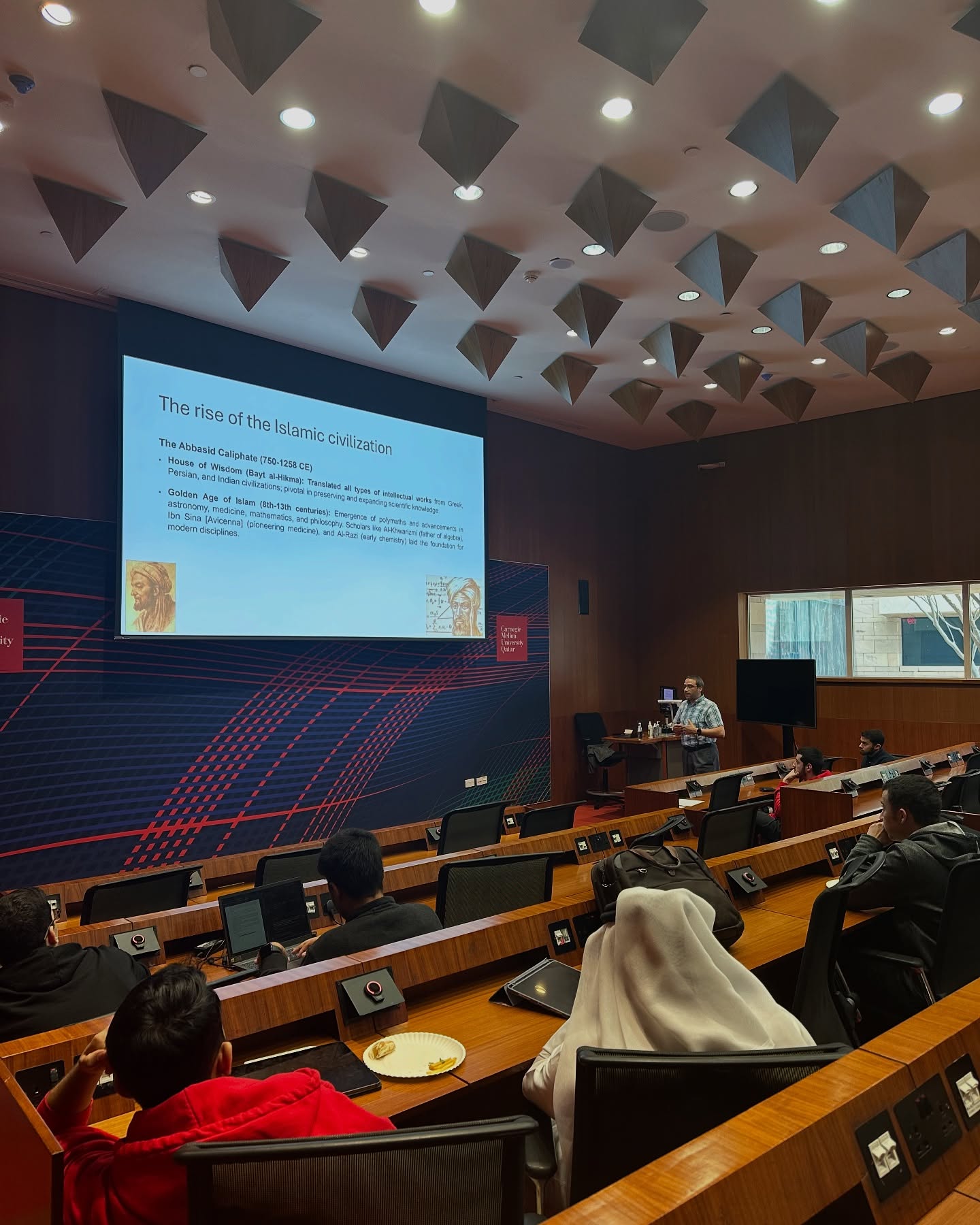 A guest speaker presenting on the rise of Islamic civilization