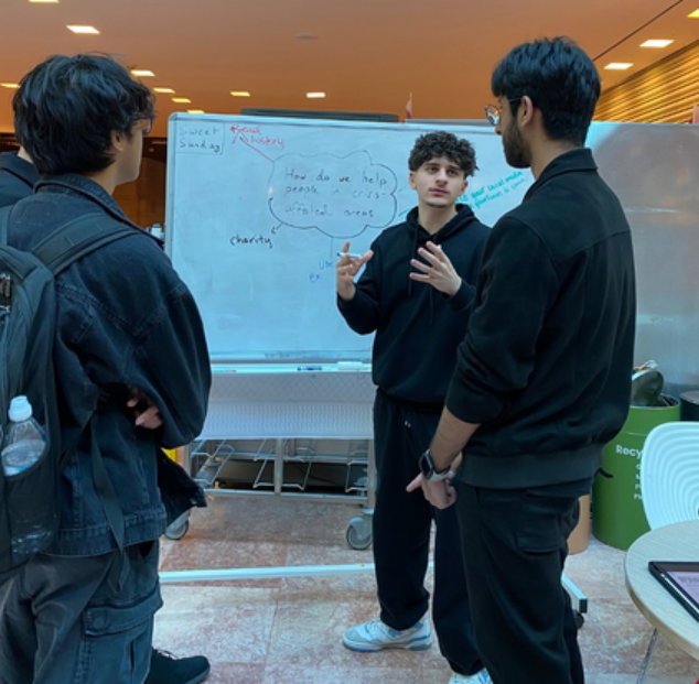 Students discussing a question at the Sweet Sunday board