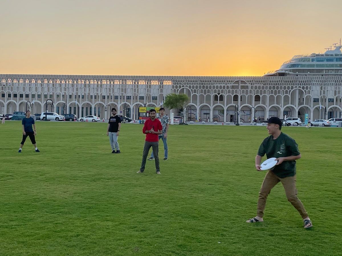 Students playing frisbee together during an MSA trip